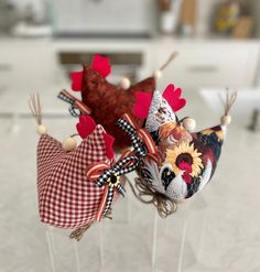 three decorative head pieces on sticks in a kitchen