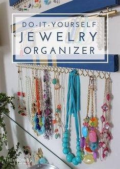 a jewelry organizer hanging on the side of a wall