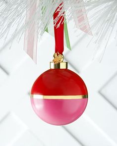 a red ornament hanging from a christmas tree