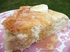 a close up of a piece of cake on a pink and white plate with grass in the background