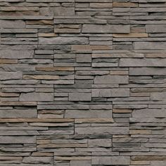 a stone wall that is made from various types of stones and has brown trim on it