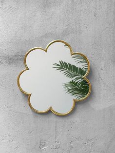 a mirror that is on the side of a wall with a palm tree in it