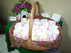 a basket filled with white paper bags on top of a table