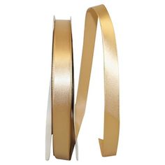 two rolls of gold ribbon on white background