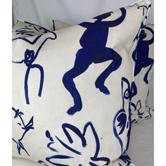 two blue and white pillows with monkeys on them