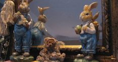 three statues of rabbits in front of a mirror