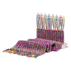 several multicolored crochet knitted items are lined up in rows and stacked on top of each other