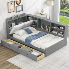 a bed with two drawers underneath it in a room