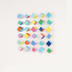 colorful geometric shapes are arranged on a white surface