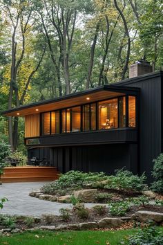 a modern house in the woods surrounded by trees