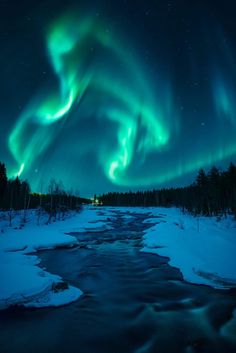 the aurora bore is seen over a frozen river