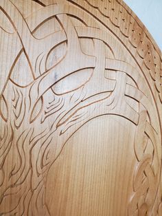 a carved wooden plaque with an image of a dragon on it