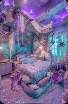 a bedroom decorated in purple and blue with mermaid decorations on the ceiling, bedding and curtains