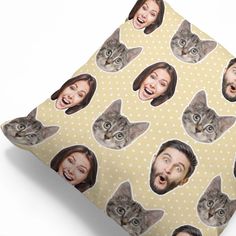 a pillow with the faces of two people and a cat on it's face