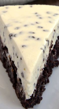 a piece of chocolate cake with white frosting and black polka dots on the top