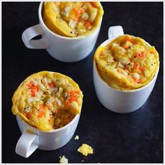 three mugs filled with food sitting on top of a table next to each other