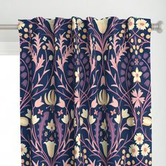 the curtain is hanging in front of a window with blue and pink floral designs on it