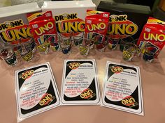 uno uno uno drinking glasses are lined up on a table with other uno uno cards