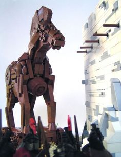 a large lego horse standing next to a tall building