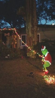 a christmas light display in front of a house with the grino on it's side