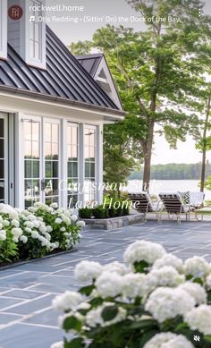 a house with white flowers in the front yard