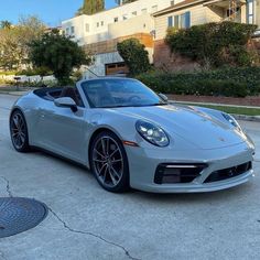 a silver sports car parked in front of a house