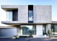 a modern house with large windows and white doors