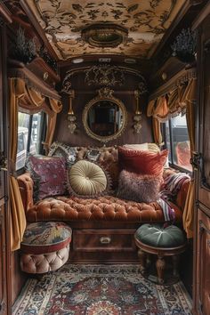 the inside of an old train car with many pillows and cushions on it's seat