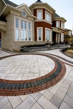 a large brick driveway in front of a house