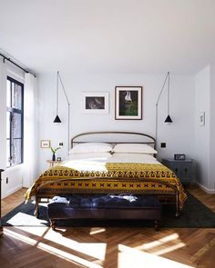 a bed sitting in the middle of a bedroom on top of a hard wood floor