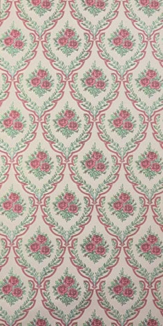 a pink and green flowered wallpaper with red flowers on it's side