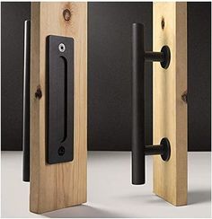 two wooden doors with black handles on them