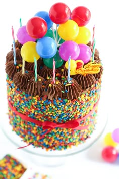 a birthday cake with chocolate frosting and colorful sprinkles