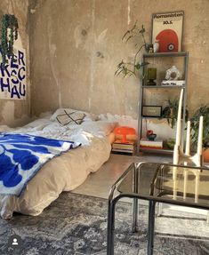 a bed sitting in a bedroom next to a book shelf filled with books and plants