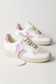 Made from sustainable materials, these retro-style leather sneakers feature colorful details and a logo on the side. * Padded collar and footbed * Low-top style * Textured rubber sole **VEJA** VEJA sneakers are made using fair trade principles and are composed of raw and wild materials sourced from organic farming and ecological agriculture, without chemicals or pollutants. They work directly with the Seringueiro community in the Amazon Rainforest to harvest wild rubber, which is used in the sole of every VEJA sneaker. Each pair of VEJA sneakers is produced in the same factory in the state of Rio Grande do Sul in southern Brazil. | Veja V-10 Sneakers at Free People in Purple, Size: EU 39 Organization Shoes, Shoes Dressing, Dressing Shoes, Shoe Outfits, Storage Shoes, Shoe Organization, Shoes Dresses, Veja V 10, Shoes Storage