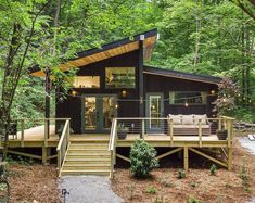 a house in the woods with stairs leading up to it