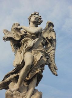 an angel statue on top of a building