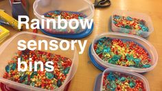 several plastic containers filled with colorful beads on top of a wooden table next to scissors