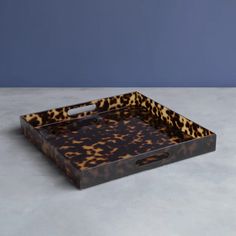 an animal print tray with handles on a table