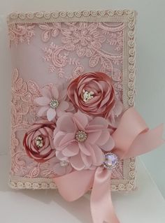 a close up of a decorative object with flowers on it's side and pink ribbon around the edges