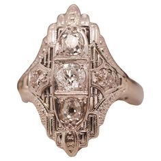 an antique diamond ring with three stone accents