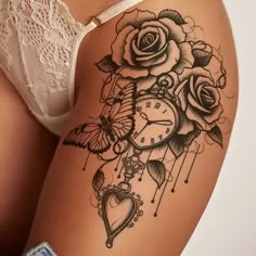 a woman's thigh with roses and a clock tattoo on her side, next to a white bra