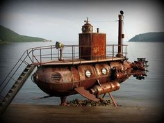 an old rusted ship sitting on top of a wooden dock