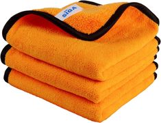 four yellow towels stacked on top of each other in front of a white background with black trim