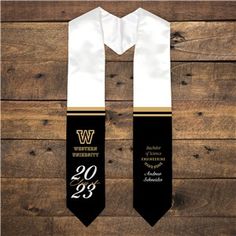 two black and white neck ties with the number twenty nine on them, against a wooden background