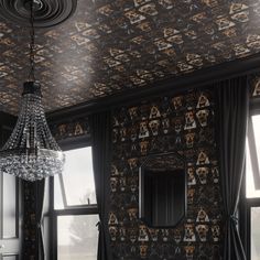 a chandelier hanging from the ceiling in a room with black and white wallpaper