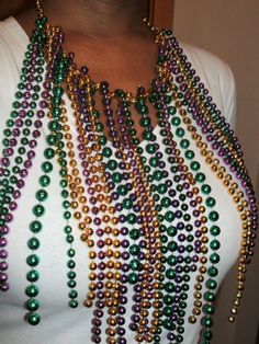 a woman wearing a multi colored beaded necklace