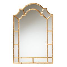 a mirror that is sitting on top of a table next to a white wall with a gold frame