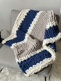 a crocheted blanket sitting on top of a chair