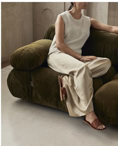 a woman sitting on top of a green chair